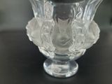 a glass vase with a flower inside of it on a table