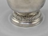 a silver bowl sitting on top of a metal stand
