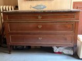 a dresser that has a marble top on top of it
