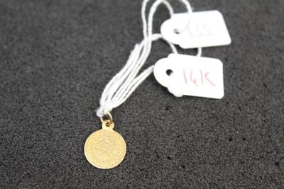 a close up of a gold coin on a string with a price tag