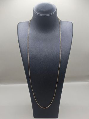 a gold chain necklace on a mannequin display