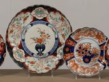 five plates with different designs on them sitting on a table