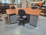 a desk with a chair and a computer on it