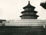 a black and white photo of a building in the middle of a field