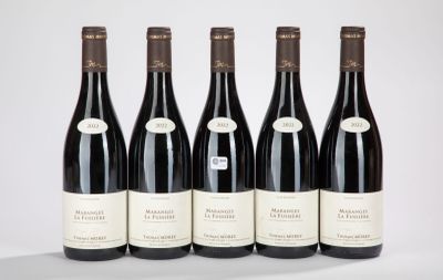 six bottles of wine are lined up on a table