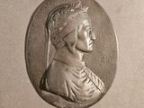 a silver coin with a woman ' s profile on it