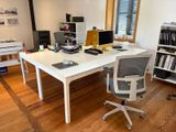 a white desk with a computer on it in a room