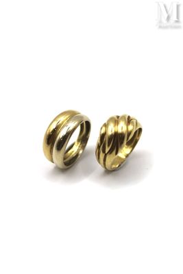 a pair of gold plated metal beads on a white background