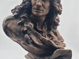 statue of a woman with long hair and a flower in her hair