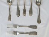 beaucoup de cuillères et de fourchettes en argent sur une table