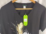 the t shirt is black with gold and white flowers on it