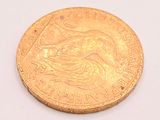 a gold coin with a picture of a woman on it