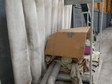 several rolls of fabric are stacked on a cart in a warehouse
