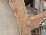 a close up of a chair with a wooden arm rest