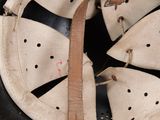 a close up of a helmet with a leather strap on it