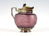 a purple vase with a bird on it on a white surface