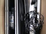 three laptops in a box with wires and cords