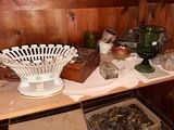 a shelf that has a lot of glass items on it