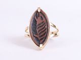 a close up of a ring with a leaf design on it