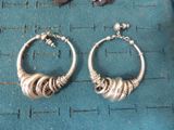 a pair of earrings that are sitting on a table