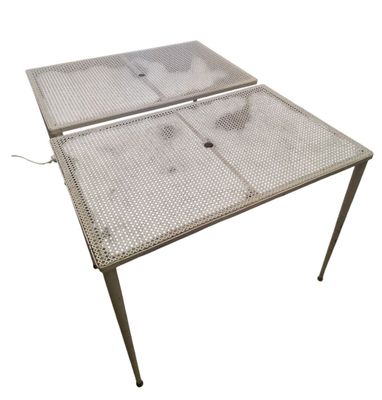 an image of a metal table with a metal mesh top