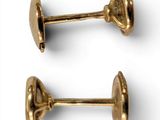 two pairs of gold plated cufflinks on a white background