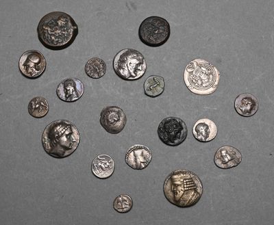 several different types of coins are arranged in a circle on a gray surface