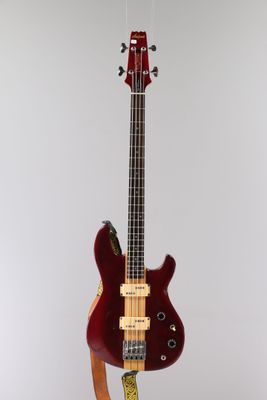an electric bass guitar on a stand on a white background