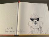an open book with a drawing of a woman in a hat and dress
