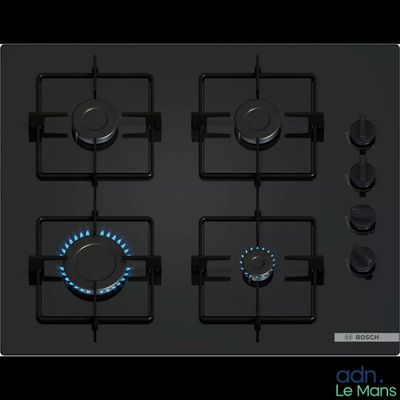 four burners on a black stove top with a blue flame
