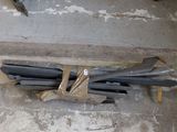 a pile of steel bars on the ground in a room