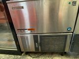 a stainless steel refrigerator in the middle of a room