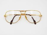 pair of glasses on a white surface with a white background