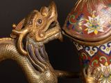 an oriental vase with a dragon on it and a dragon on the lid