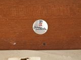 a close up of a piece of wood with a sticker on it