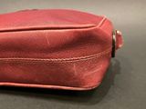 a close up of a red purse on a table