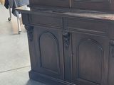 a china cabinet that has a glass door on top of it