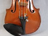 a violin that is sitting on a white surface