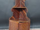 an image of a wooden corner cabinet with a shelf on top of it