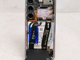 a phone that has a broken battery and some tools inside of it