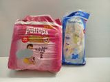 two bags of toilet paper sitting next to each other on a table