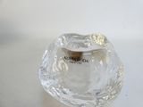 a clear glass candle holder with a gold ring on it
