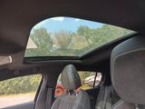 a view of the sunroof from inside of a car
