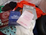 a pile of clothes and books on a bed