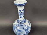 a blue and white vase sitting on a table