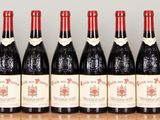 six bottles of wine are lined up in a row on a table