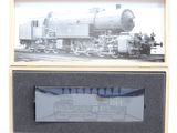 a black and white photo of a train in a wooden box