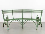 an image of a green metal bench in a white room