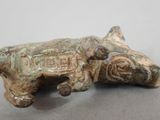 a figurine of a dog laying down on a table