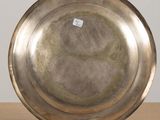 a silver plate sitting on a table with a sticker on it